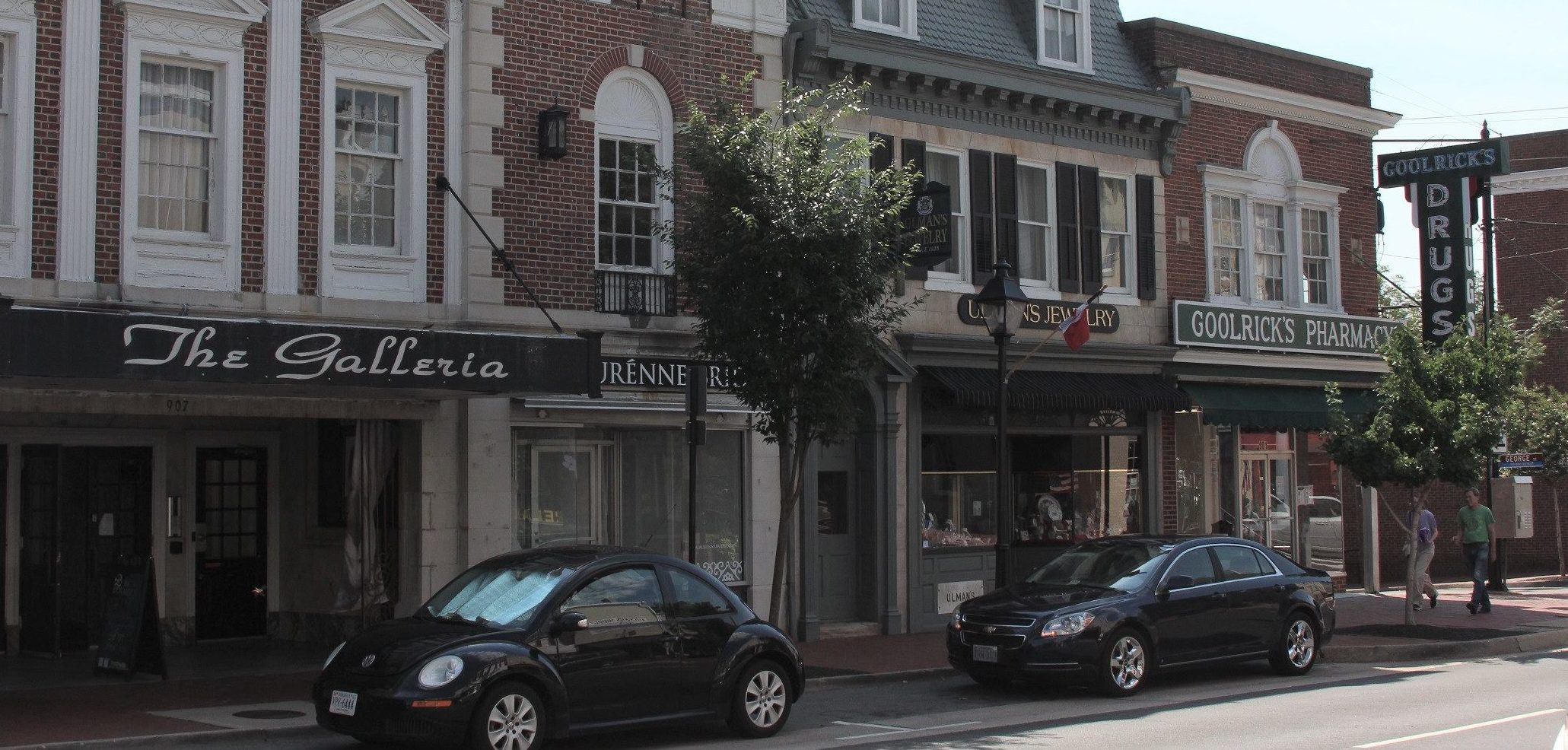 A couple of cars parked on the side of a street.