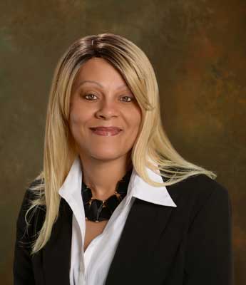 A woman in black jacket and white shirt